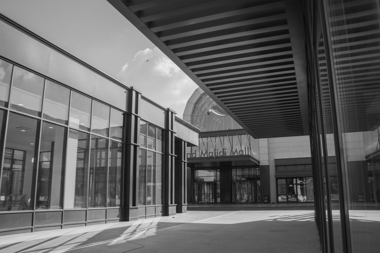 Modern architectural design of Grand Majidi Mall in black and white. Urban exterior facade.